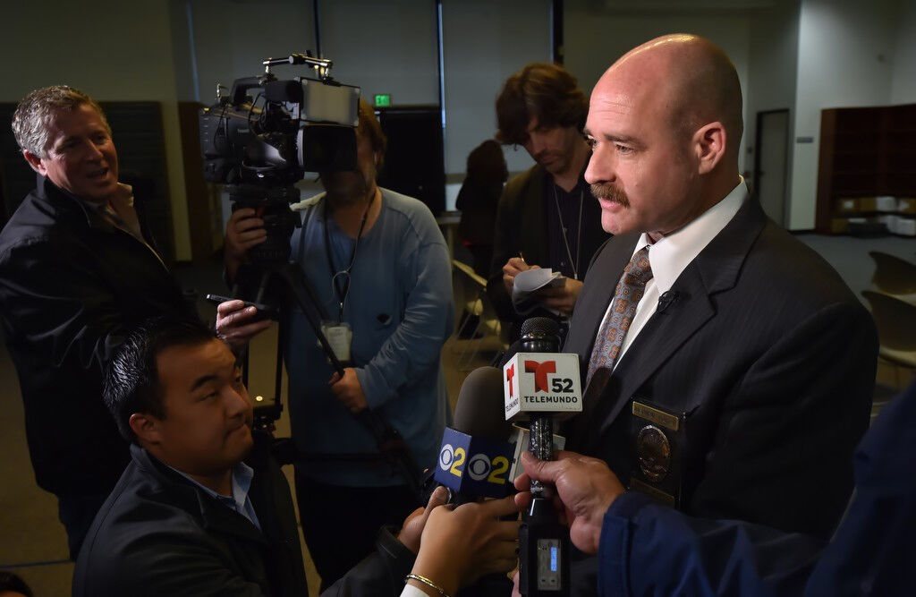 Daron L. Wyatt taking questions from television reporters at a police news conference